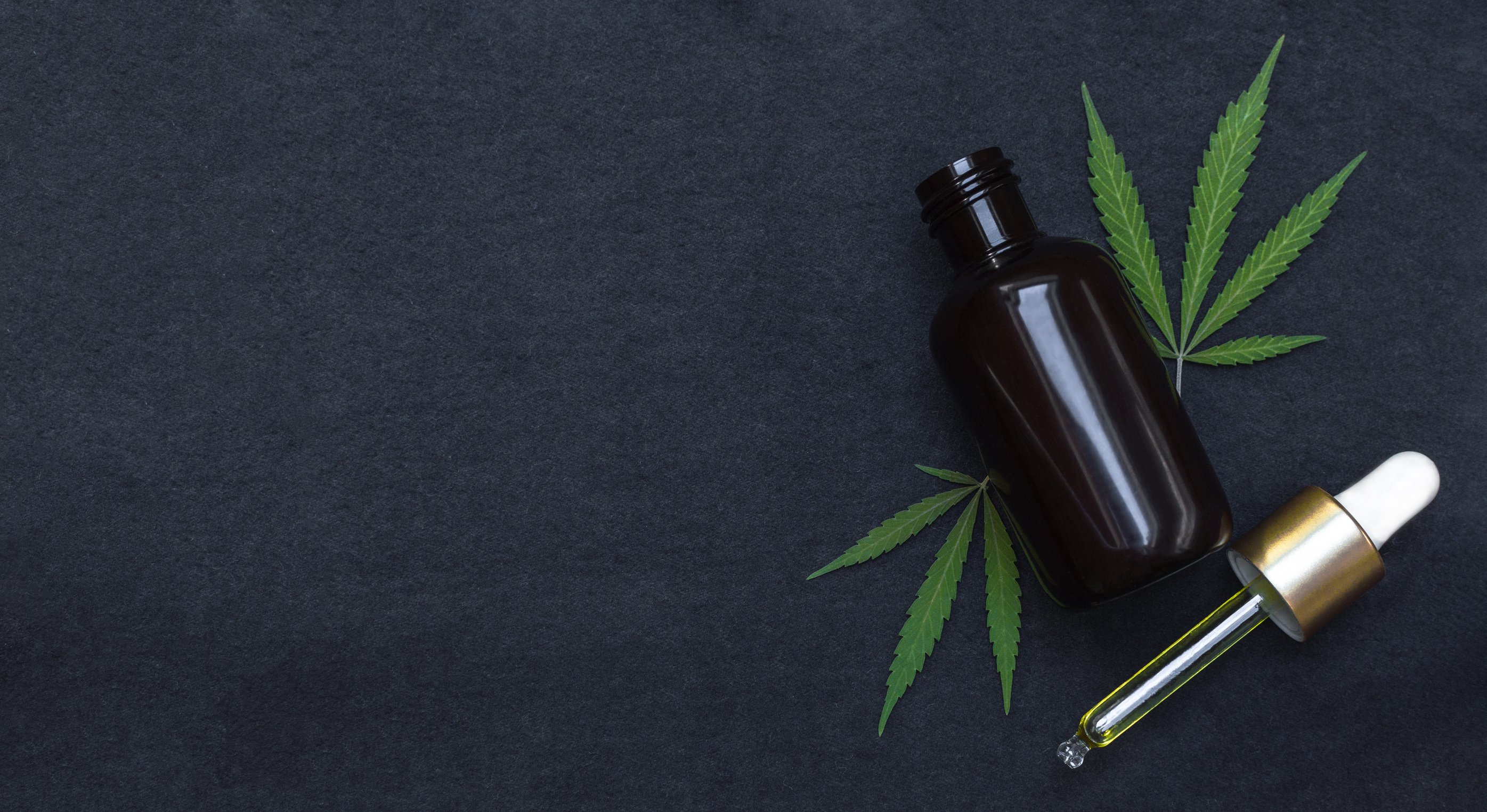 Bottle, Dropper with CBD Oil and Leaves Flatlay